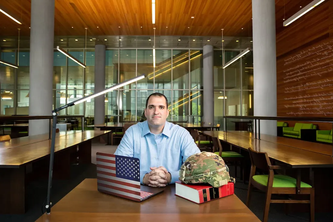 Ryan Marquette, a veteran student sitting and smiling.